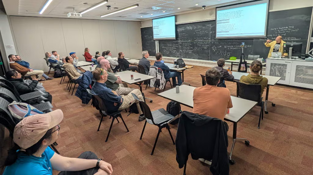 A Canberra Python meetup in progress: a speaker presenting to a room of seated attendees